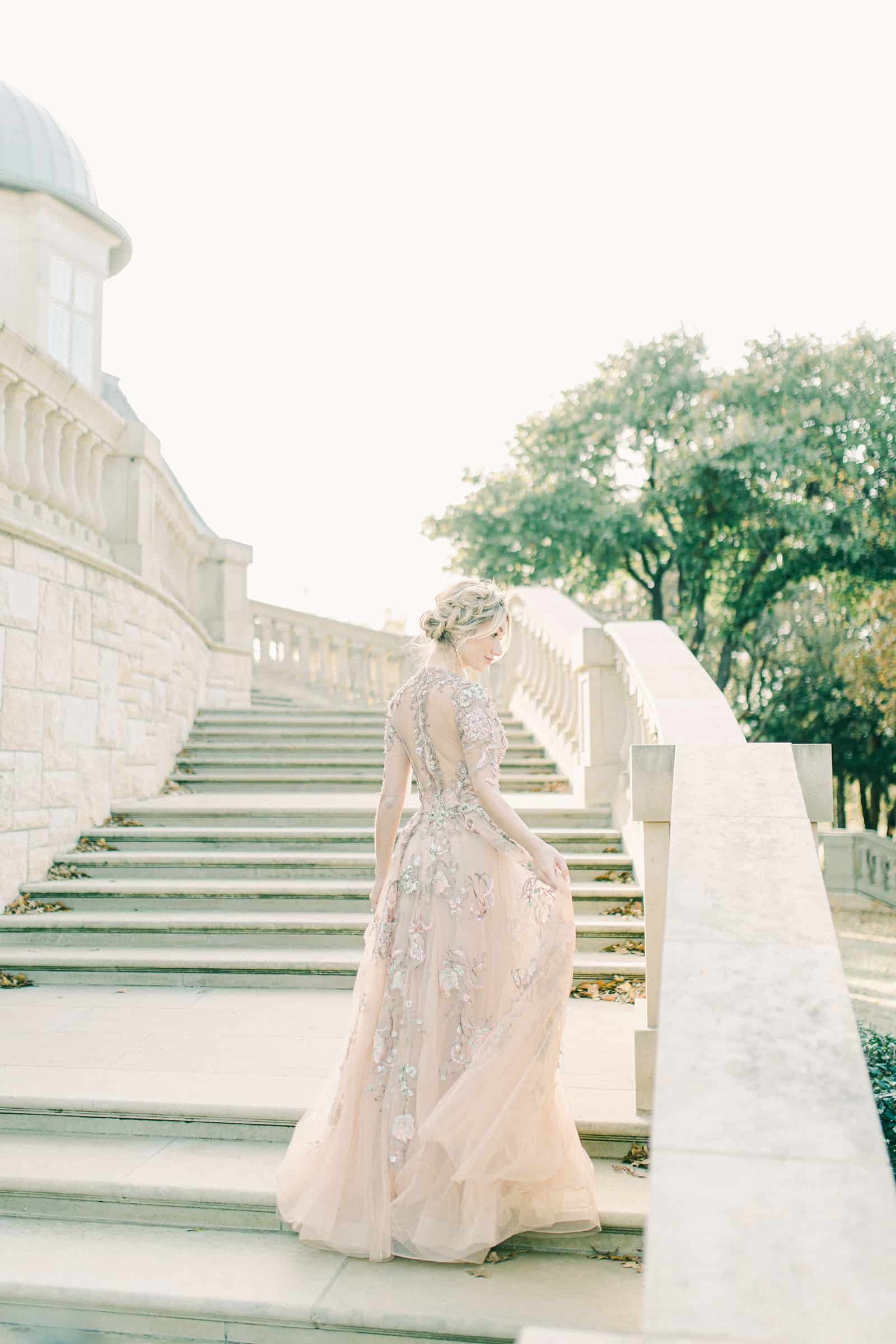 European bride on marble staircase wearing couture wedding dress, YSA Makino designer wedding dress