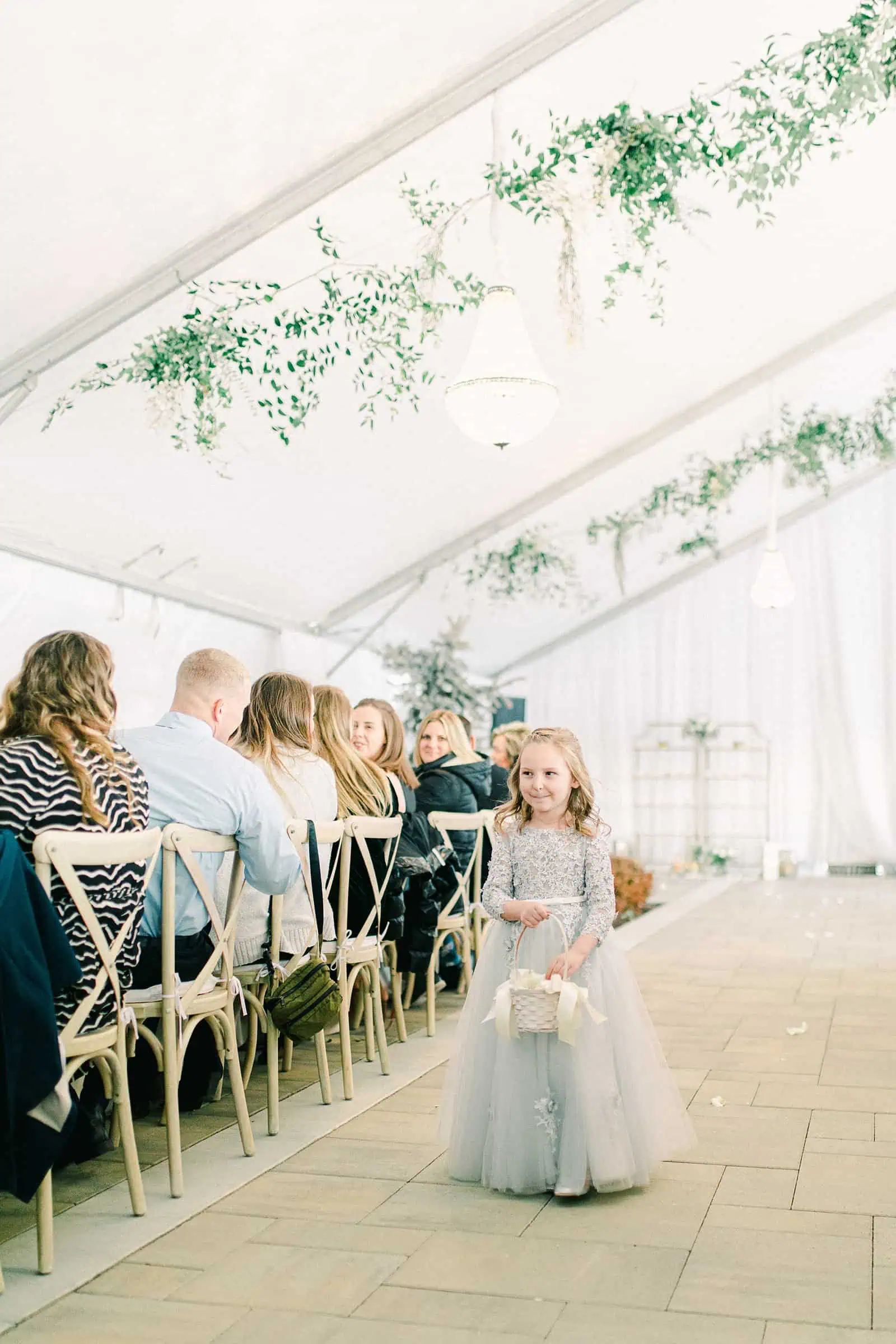 Luxury winter wedding at Willowbridge Estate in Boise, Idaho, little flower girl walks down aisle in blue flower girl dress