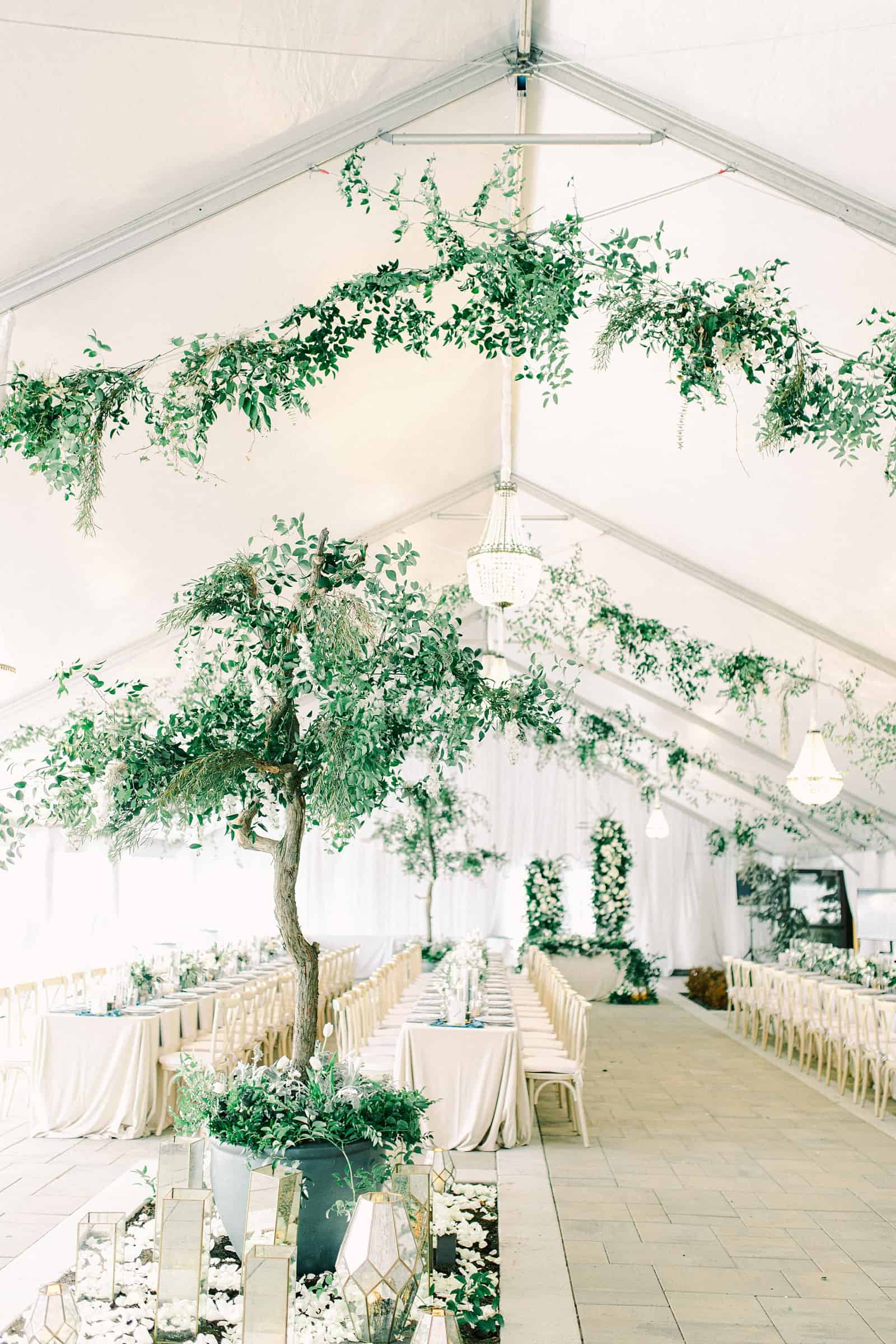 Luxury winter wedding at Willowbridge Estate in Boise, Idaho, white tent reception with greenery tree centerpieces and candles