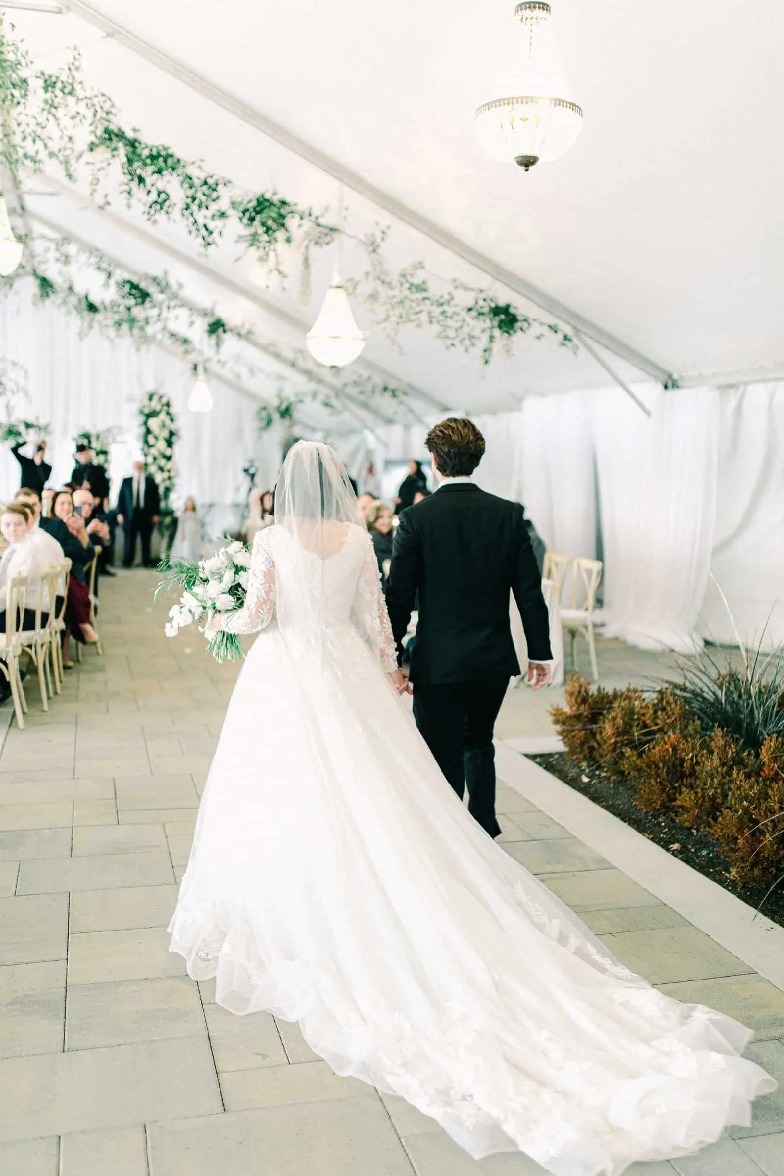 Winter wedding at Willowbridge Estate, bride and groom walk down aisle, long train