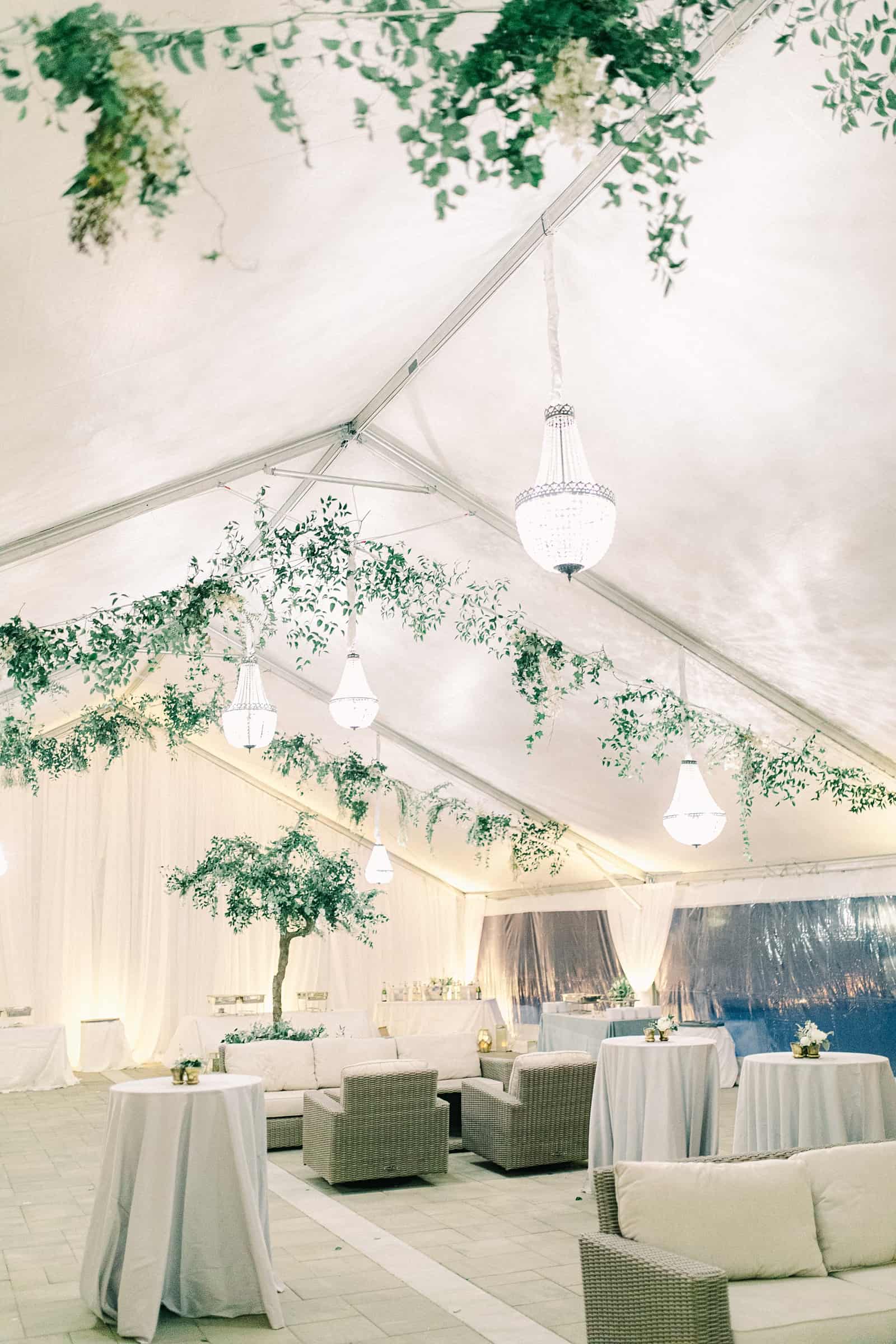 Luxury winter wedding at Willowbridge Estate in Boise, Idaho, white tent reception with greenery tree centerpieces and candles