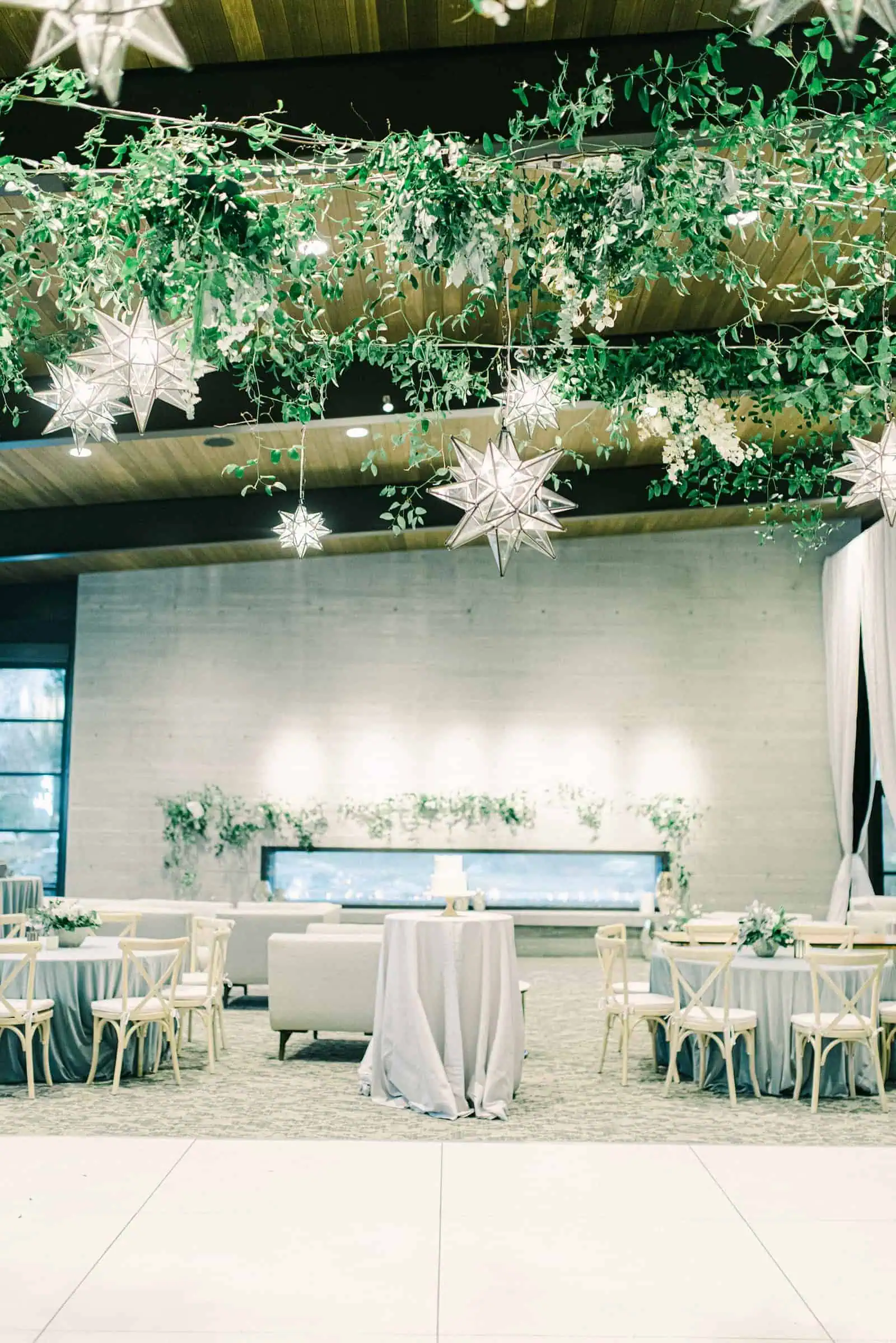 Winter wonderland wedding with star lanterns and ivy garlands, twinkle lights above dance floor