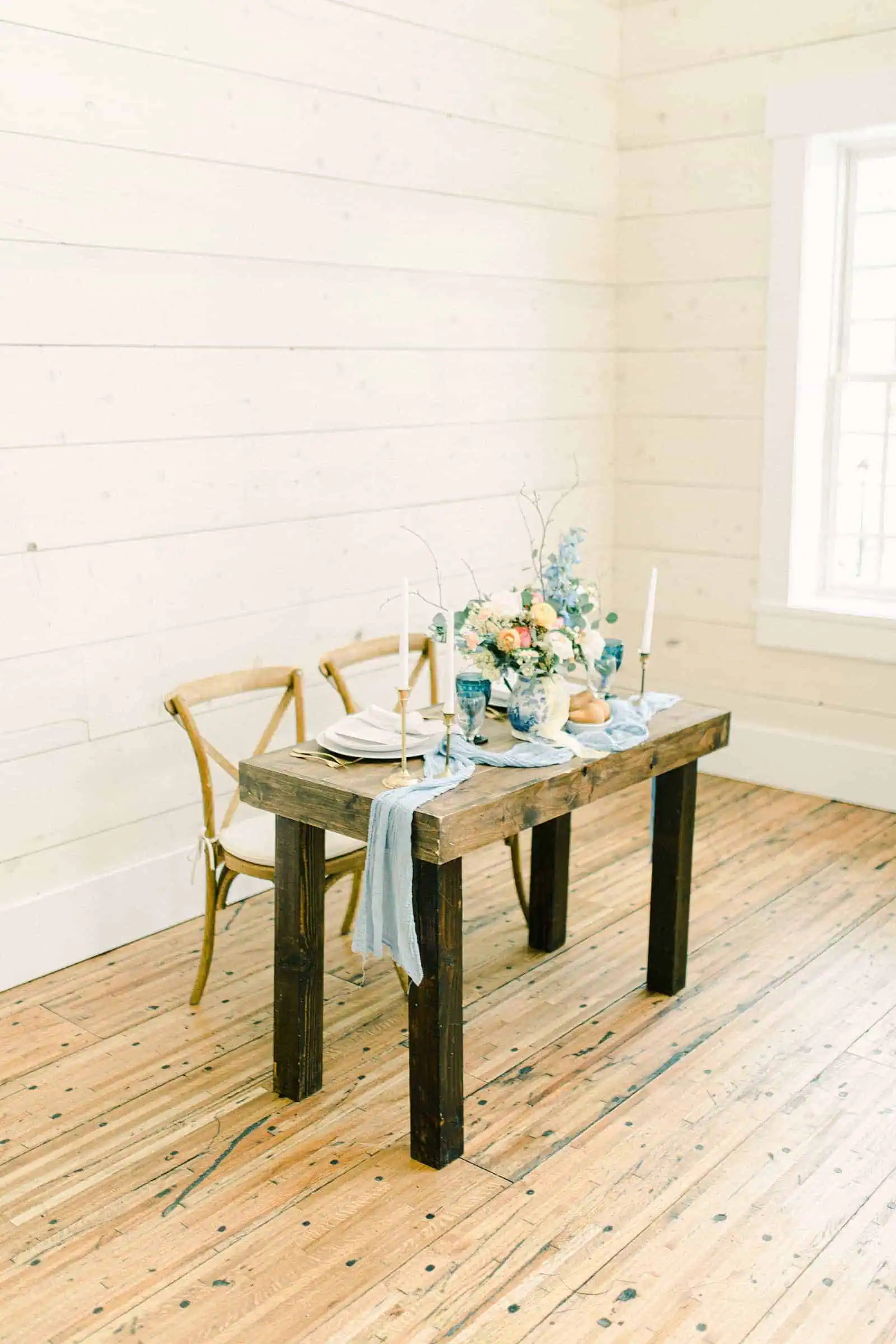 Utah wedding venue, table with light blue table runner with pastel flowers in centerpiece