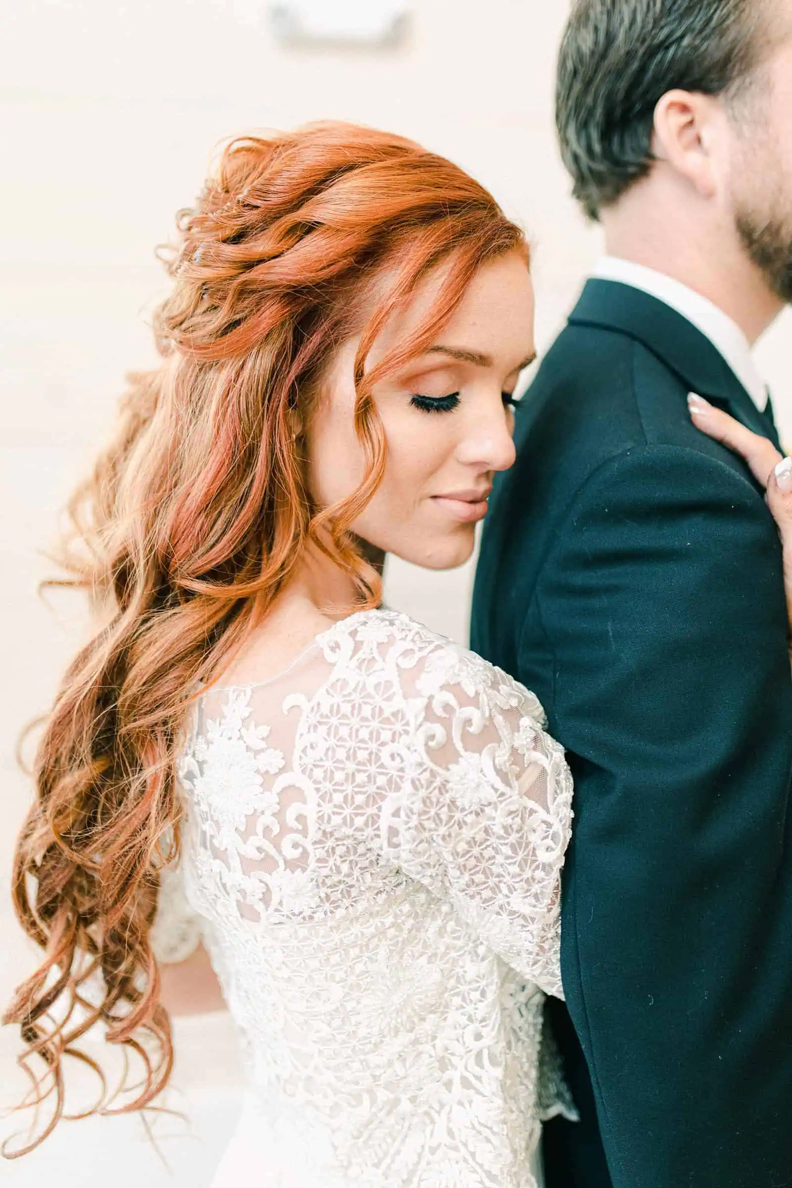 Redhead bride with wedding dress with long lace sleeves, long half up wedding hairstyle, boho bride