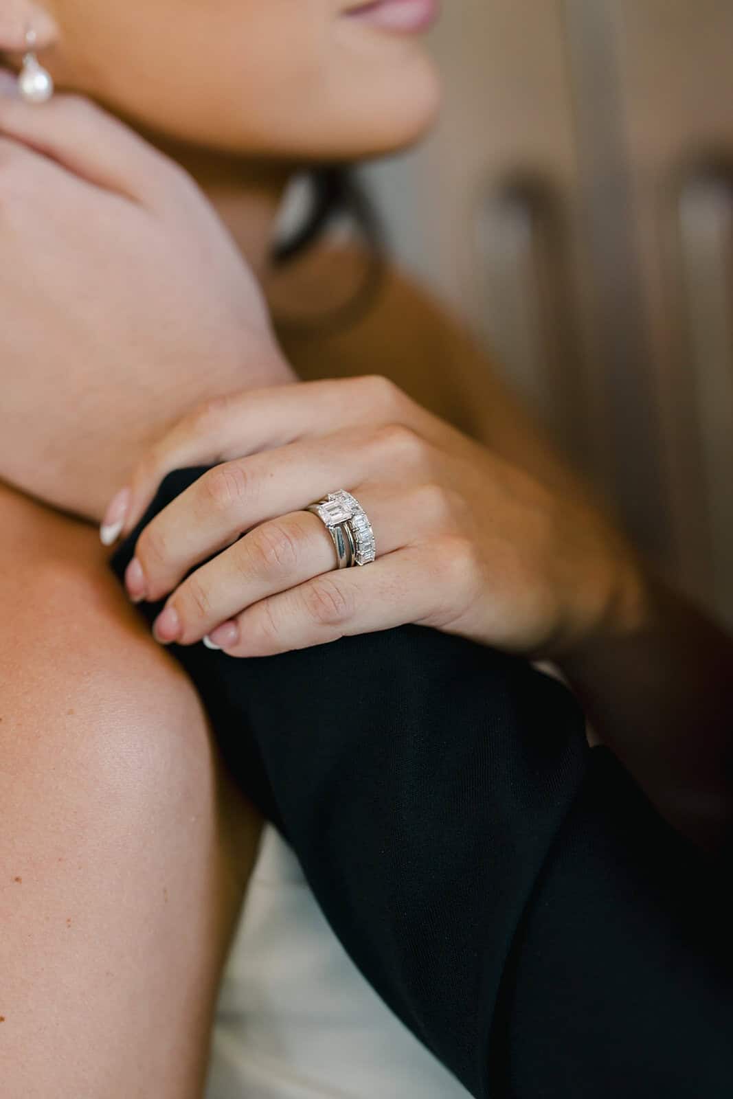 Close-up of a woman's hand with a diamond engagement ring.