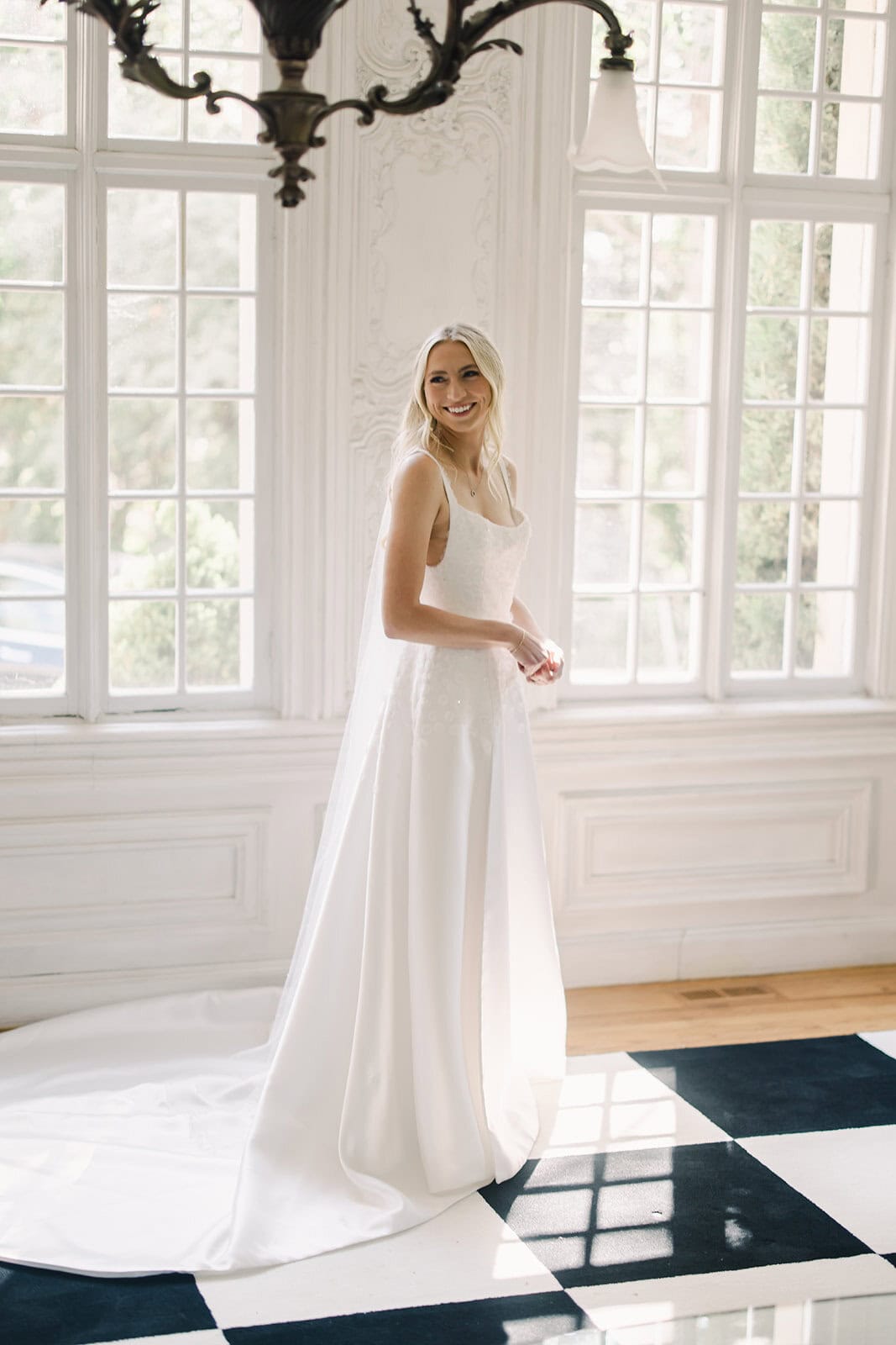Elegant white wedding gown with lace details and flowing skirt.