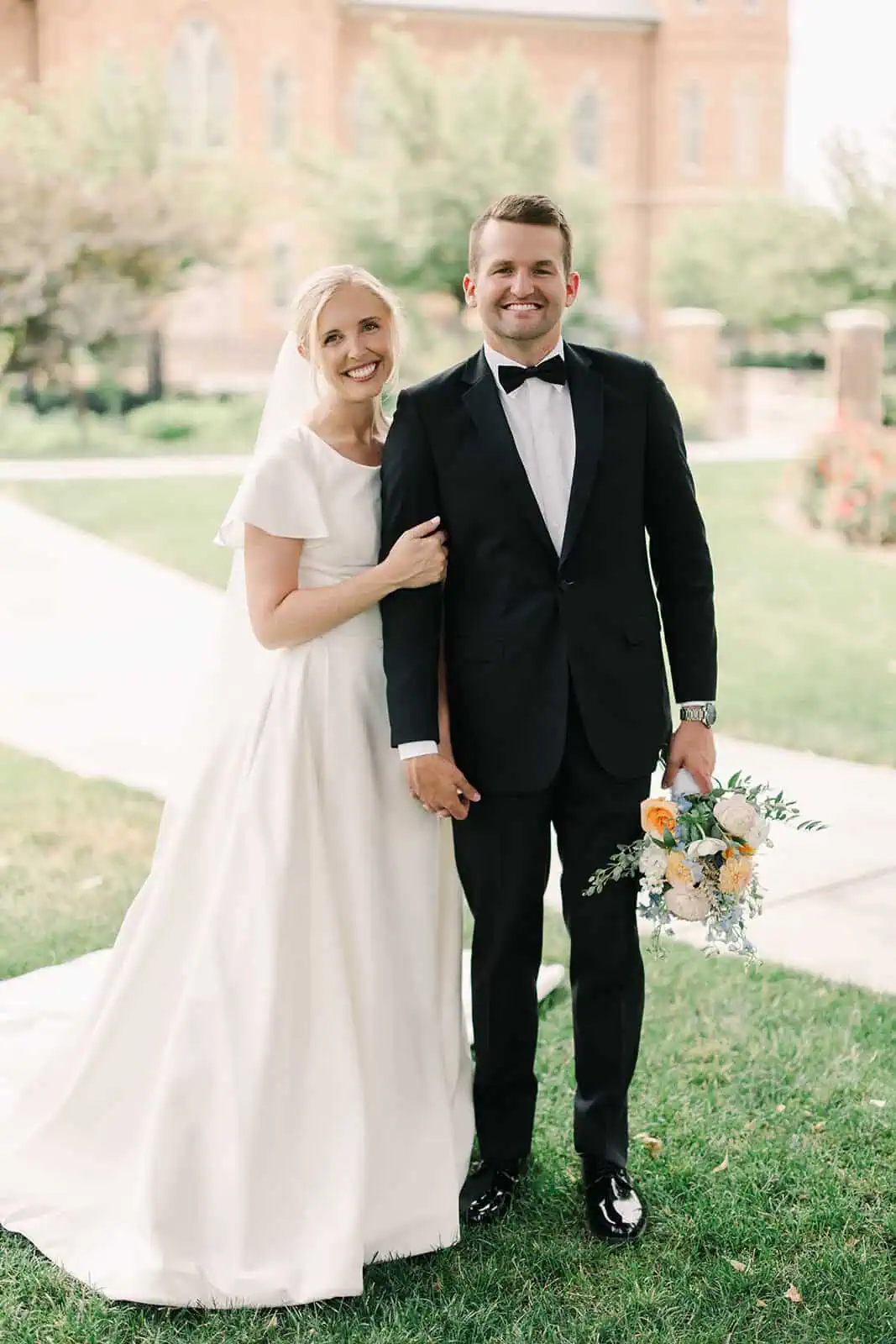 Branson Maxwell wedding couple in formal attire outdoors.