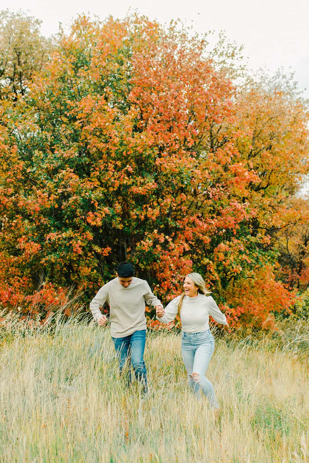 Autumn couple enjoying a walk in a colorful fall landscape.
