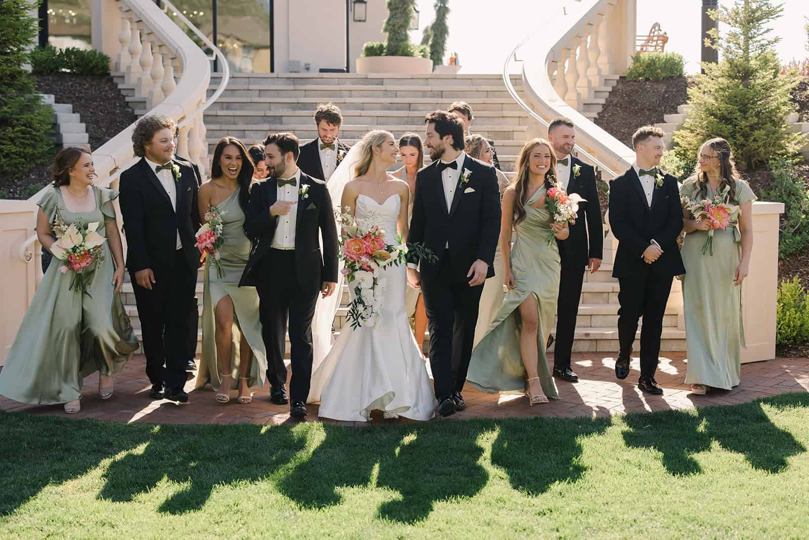 Elegant wedding party with bride and groom, surrounded by bridesmaids and groomsmen, at Branson Maxw.