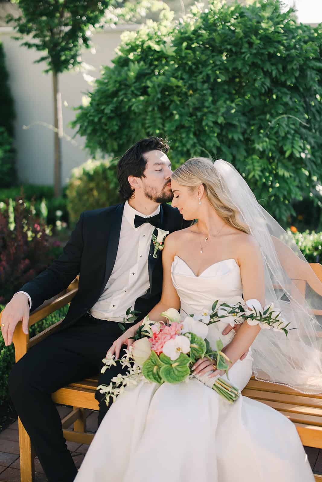 Wedding couple sharing a romantic moment outdoors.