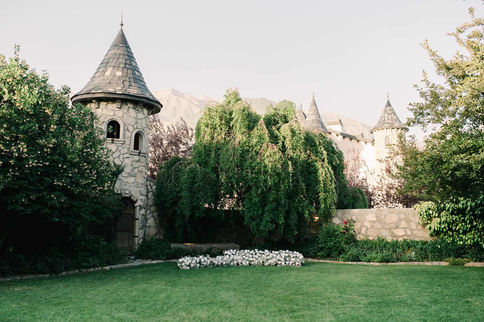 Branson Maxwell castle with lush greenery and mountain backdrop.
