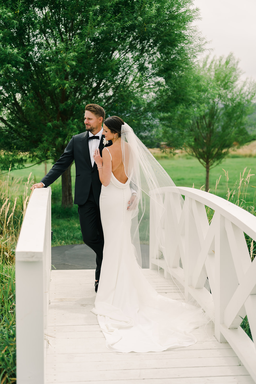 Bride and Groom on Bridge at River Bottoms Ranch Wedding 