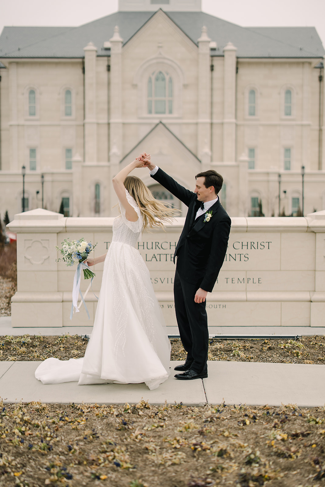 Bride and Groom Twirl in Front of Temple Wedding in Utah