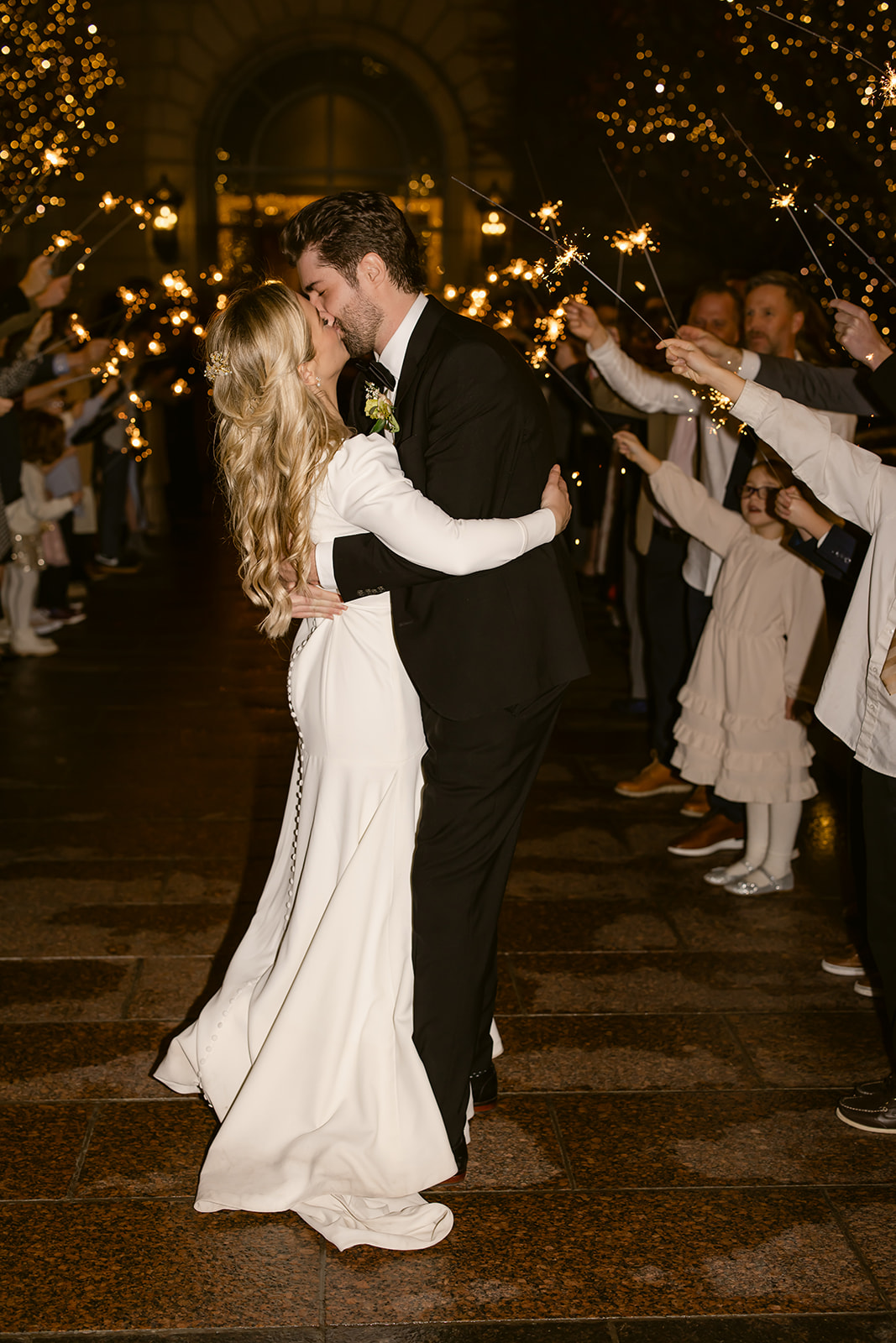Bride and Groom Kiss During Sparkler Exit at Grand America Hotel UT