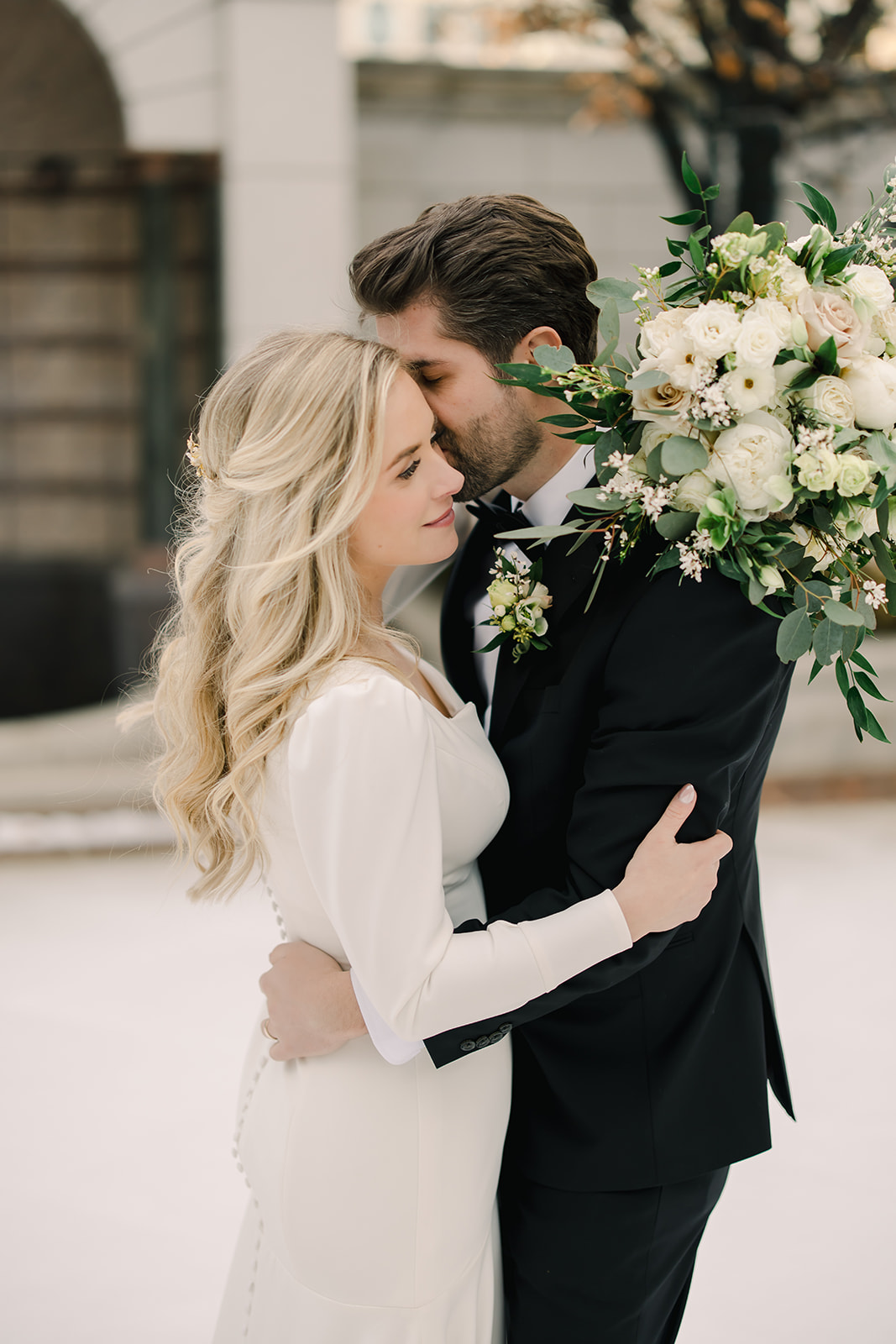 Bride and Groom Embrace After Outdoor Winter Wedding Ceremony