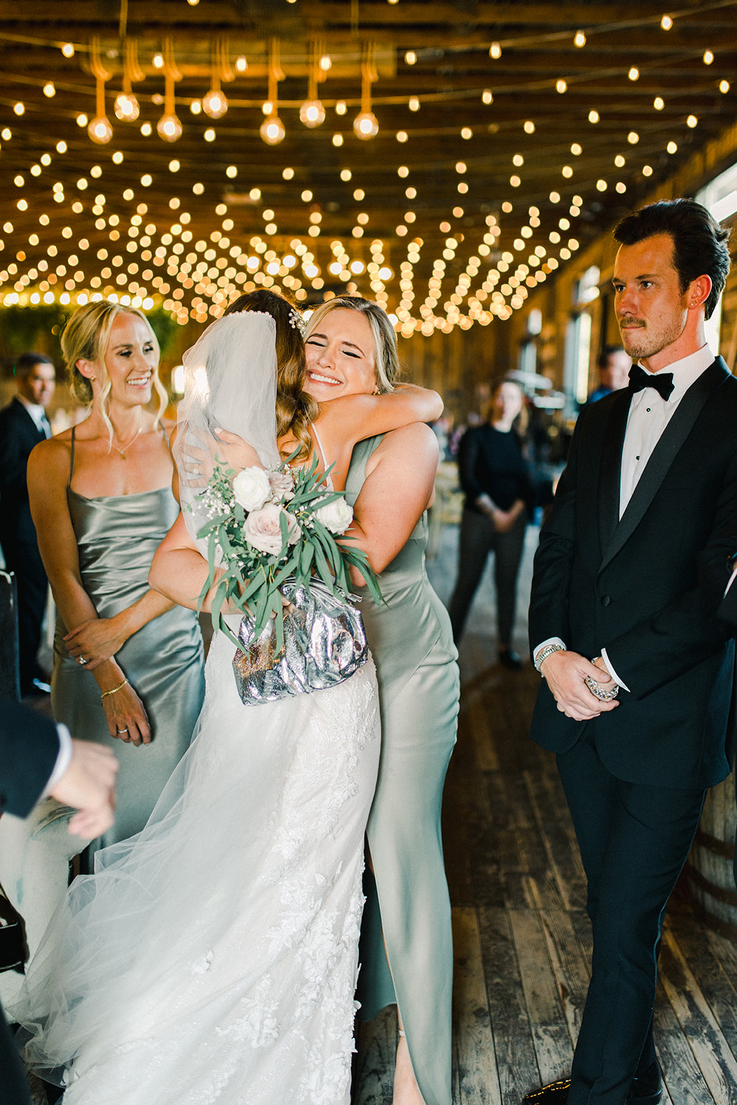 Bride and Maid of Honor Embrace After Utah Wedding Ceremony