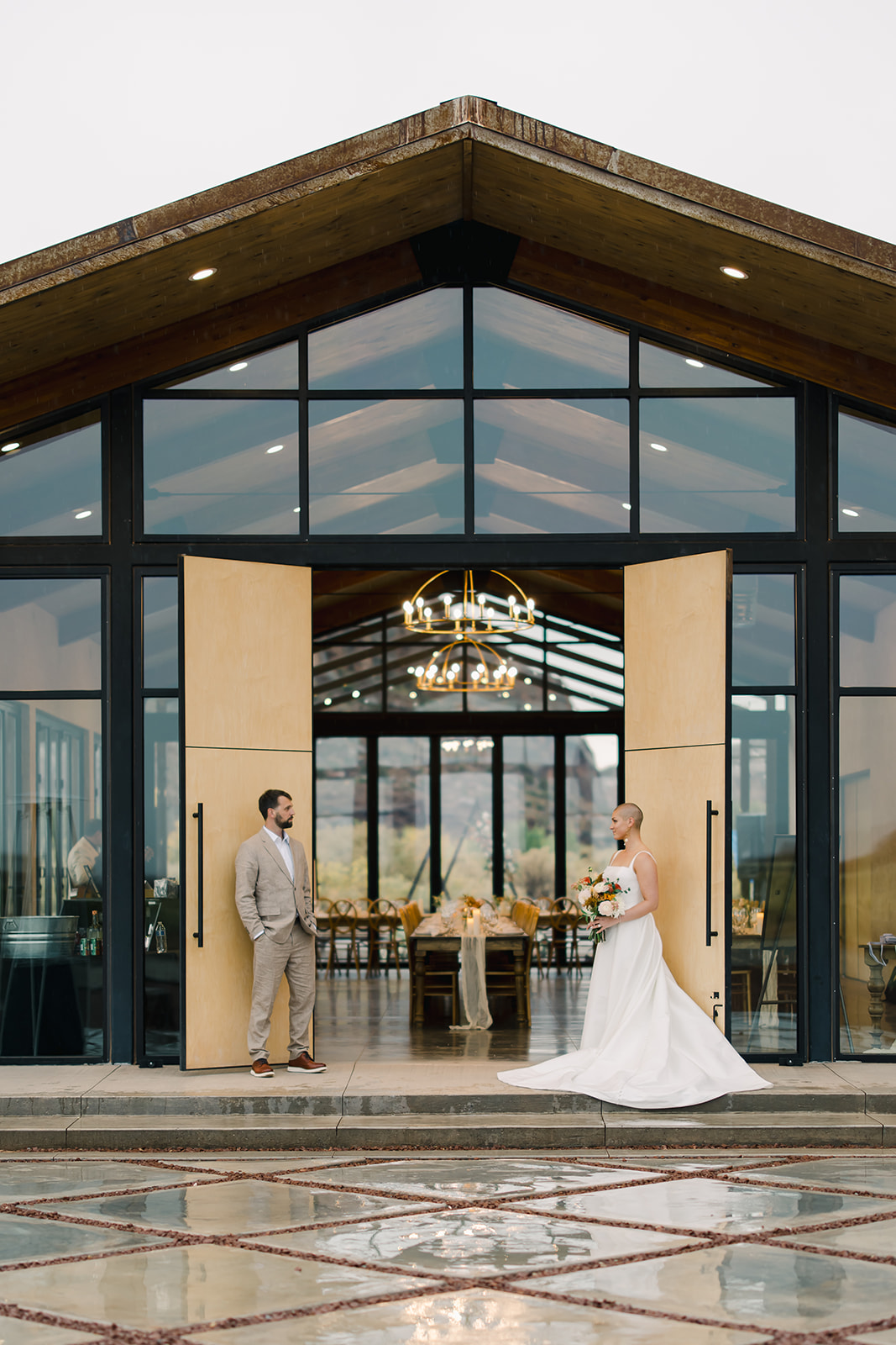 Bride and Groom Posing in Front of Doors at Red Earth Venue