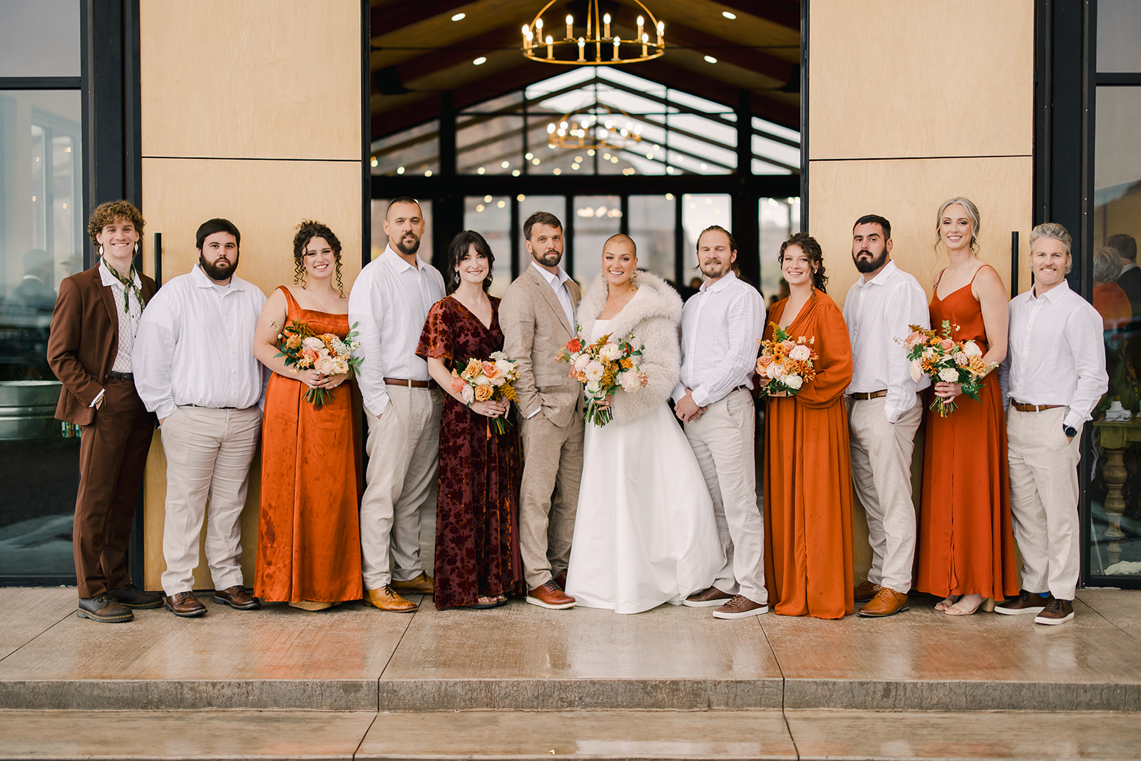 Bride and Groom Pose with Wedding Party at Red Earth Venue Wedding