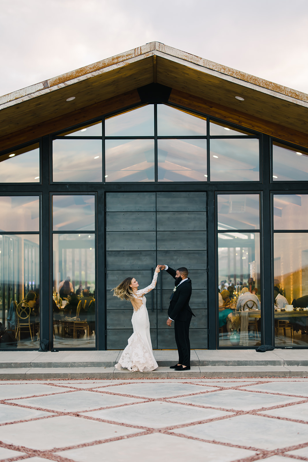 Bride and Groom Dance in Front of Red Earth Venue Wedding Reception